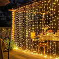 Dazzle Bright - 300-Light LED Christmas Curtain String Lights; hanging, plug-in; for outdoor use, windows, walls, weddings, patios, indoor use, bedrooms, parties, decoration, warm white.